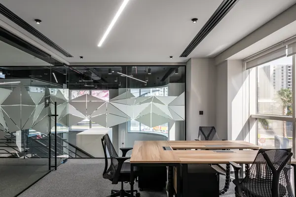 Fully furnished serviced office with ergonomic chairs and glass walls